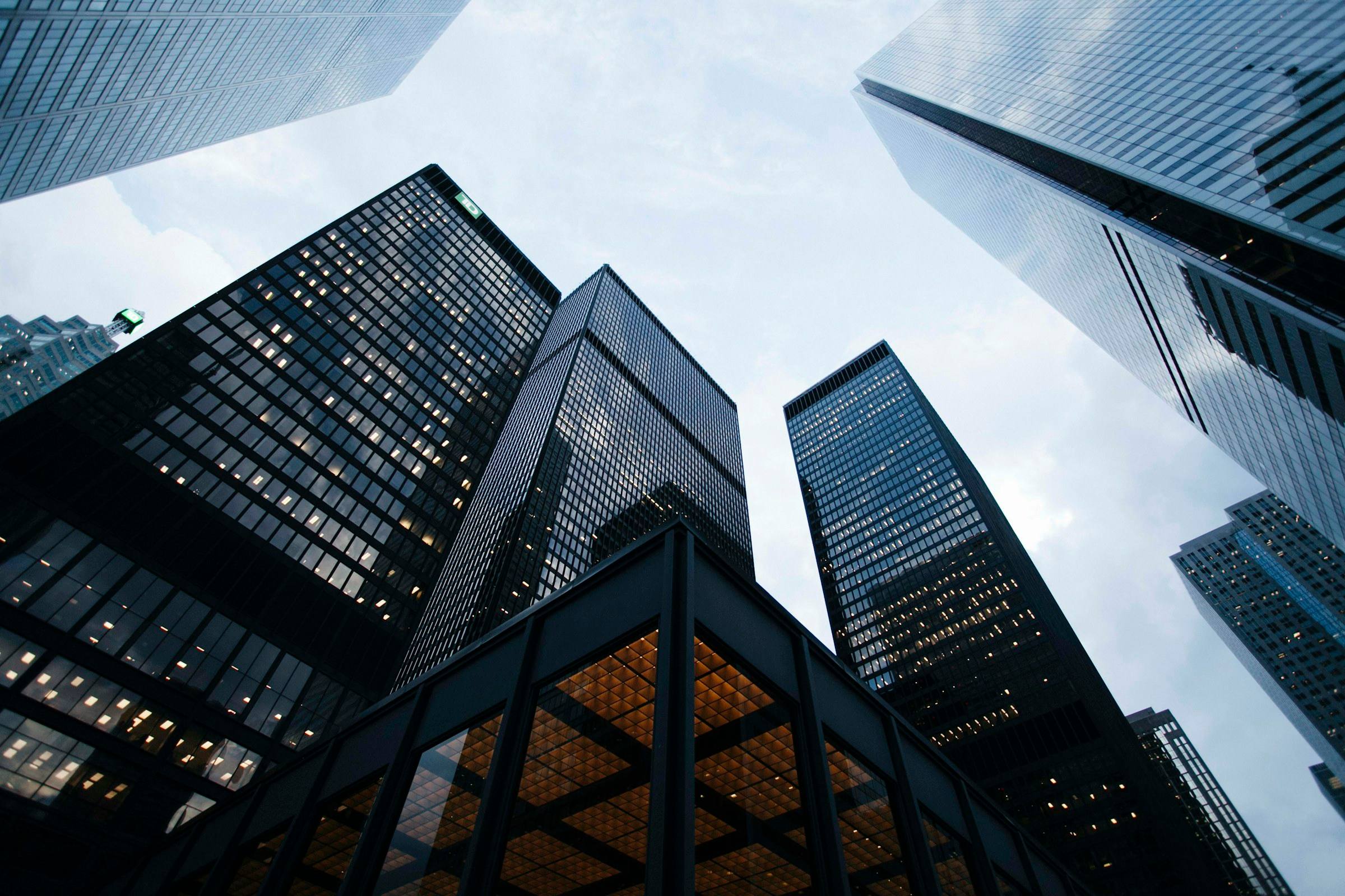Dark glass towers rising against an overcast sky